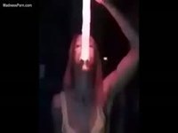 Girl deepthroating a lightsaber in the night